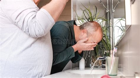 Mature Homosexual Couple Cleaning Face And Teeth In The Toilet At Home Stock Image Image Of