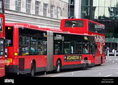 A bendy bus and a double decker bus at a bus stop in London Stock Photo ...