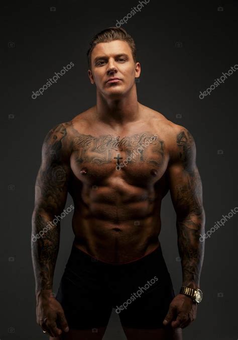 Muscular Man With Tattooes In Deep Shadows Stock Photo By Fxquadro