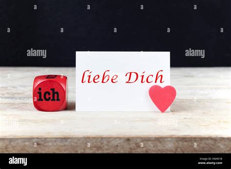 Valentine Greeting Card On Wooden Table With Text Ich Liebe Dich