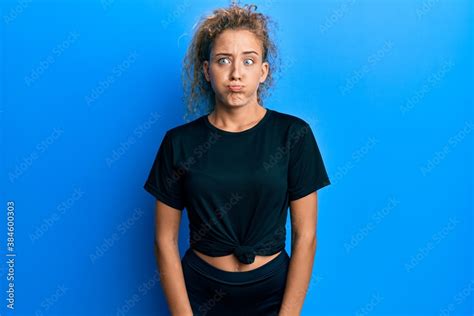 Beautiful Caucasian Teenager Girl Wearing Black Sportswear Puffing