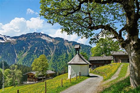 Bergdorf im Sommer mit Blumenwiesen und Kapelle Stock Photo | Adobe Stock
