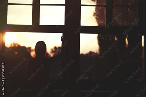 Beautiful Naked Woman Sitting On A Window At Sunset Stock Photo Adobe Stock