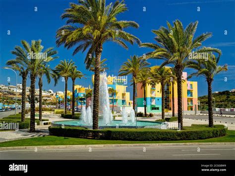 Albufeira marina, the fountain and apartments Stock Photo - Alamy