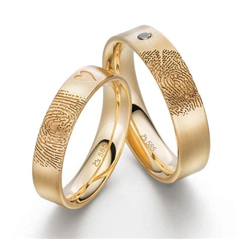 Two Gold Wedding Rings With Fingerprints On Them