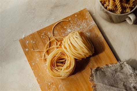 Premium Photo Homemade Pappardelle Raw Pasta On Wooden Board In