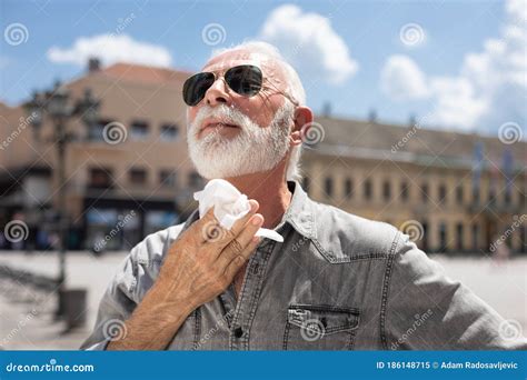 Old Man Cleaning Neck And Sweat With Wet Wipes Outdoor On Hot Summer Day Stock Image Image Of