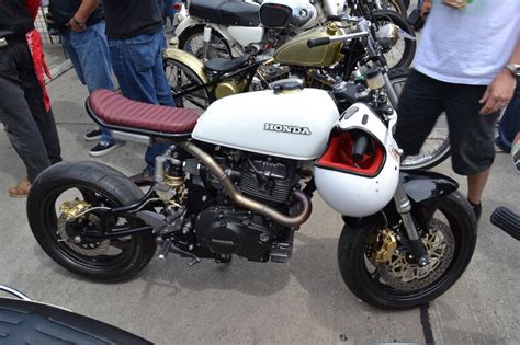 A Group Of Motorcycles Parked Next To Each Other In A Parking Lot With