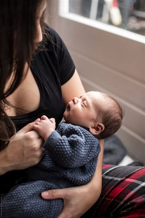 Baby Sleeping In Mother S Arms By Stocksy Contributor Eva Plevier