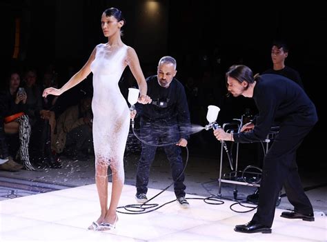Bella Hadid Gets A Dress Sprayed On Her Nude Body For A Total Fashion Magic Trick