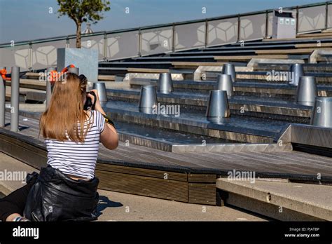 Young woman taking pictures in the roof of Nemo Science Museum in ...