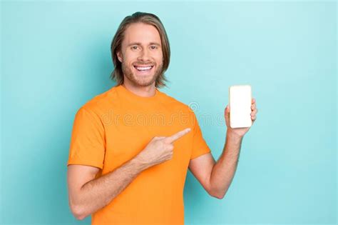 Photo Of Positive Cute Man Wear Orange T Shirt Pointing Finger Modern