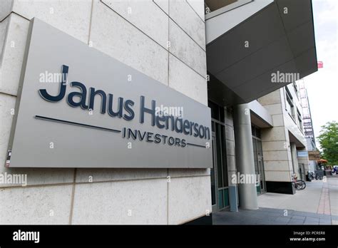 A logo sign outside of a facility occupied by the Janus Henderson Group ...