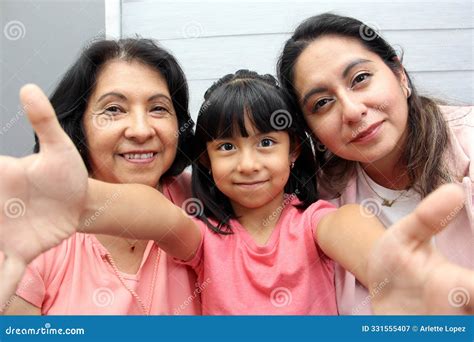 Three Generations Of Women Grandmother Mom And Latina Daughter With Glasses Show Their Love And