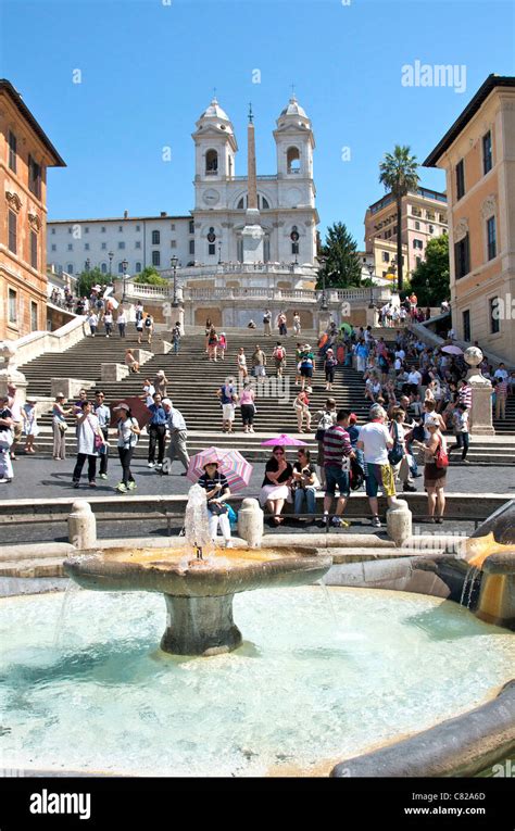 Fontana Della Barcaccia Fountain And Tourists On The Spanish Steps