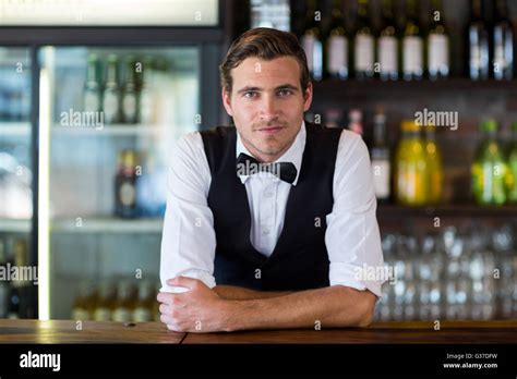 Portrait Of Bartender Leaning On Bar Counter Stock Photo Alamy