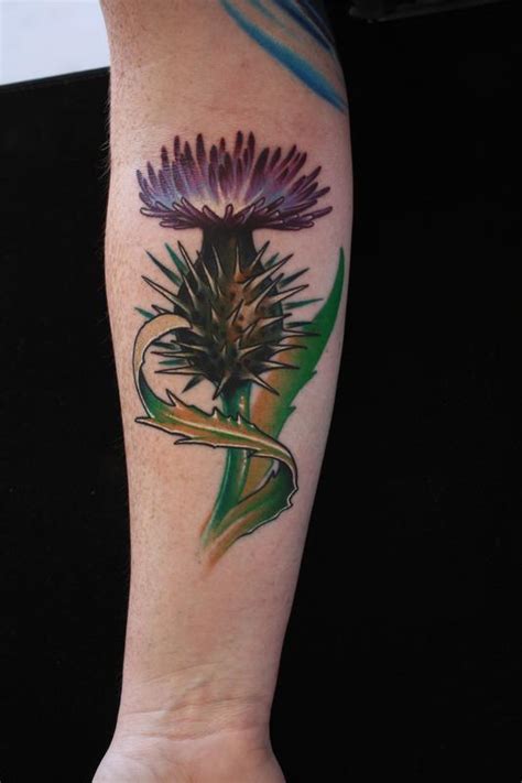 Thistle flower tattoo by Ty McEwen: TattooNOW