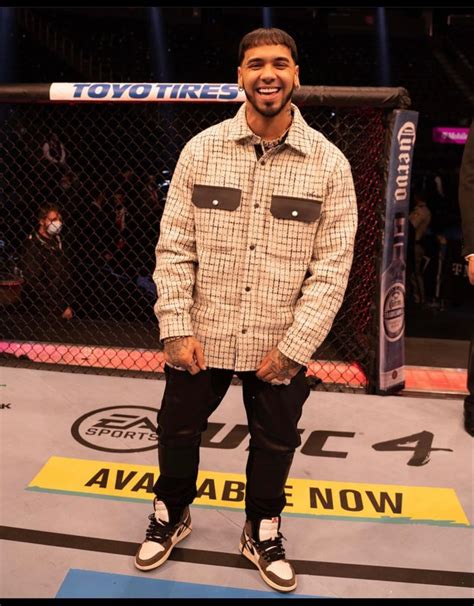 A Man Standing On Top Of A Blue And Yellow Floor Next To A Caged In Area