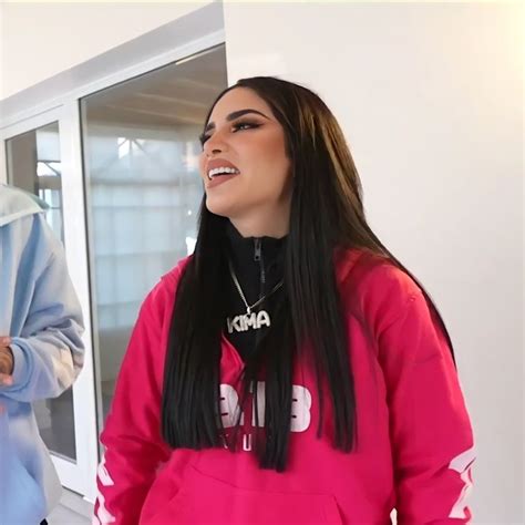 Two Women Standing Next To Each Other In Front Of A Window Wearing Pink Sweatshirts