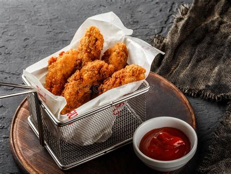 Fried Crispy Chicken Nuggets With Ketchup On Black Stone Background