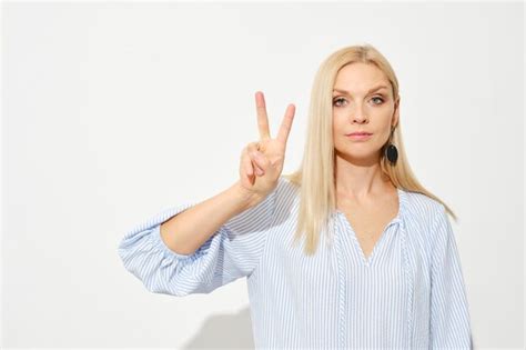 Premium Photo Attractive Blonde Woman Shows Two Fingers Counting With Fingers