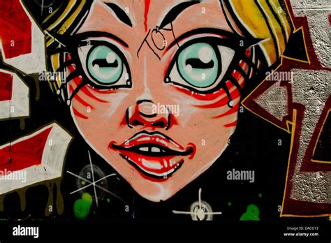 Graffiti street art Berlin wall cartoon girl face Stock Photo - Alamy