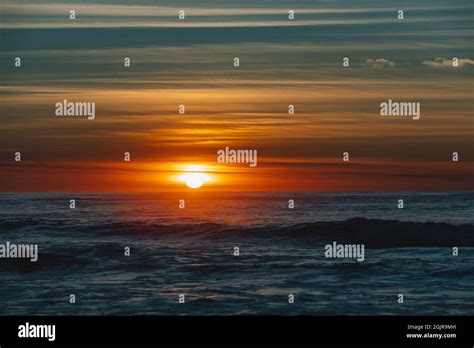 Colorful Ocean Beach Sunrise With Deep Blue Sky And Sun Rays Stock