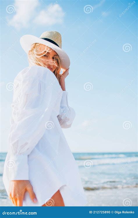 Beautiful Blonde Slim Woman Wearing Black Bikini And White Shirt Walk On Beach Of Sea Or Ocean