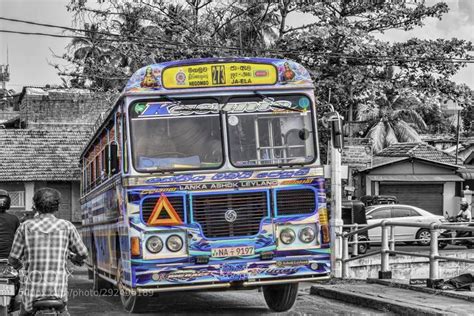 a colorful bus is parked in front of a man and child on the side of the ...