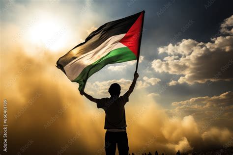 Happy man holding Palestine flag in the sunset sky, freedom and ...