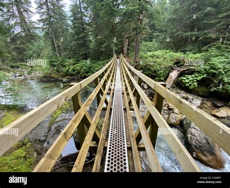 Wooden bridge over the river Stock Photo - Alamy