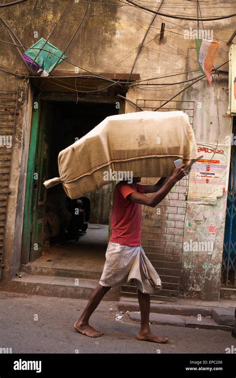 man carrying sack   head kolkata west bengal india stock photo