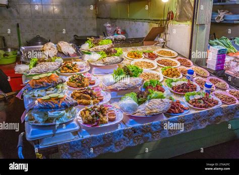 Thai Street Vendor Offers Fresh Cooked Seafood At The Night Market In