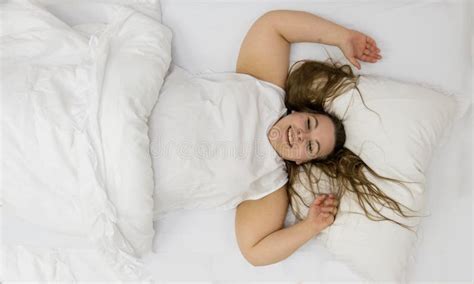 Top View Of Happy Positive Cheerful Fat Plump Woman Portrait With Long Hair In Bed Brunette