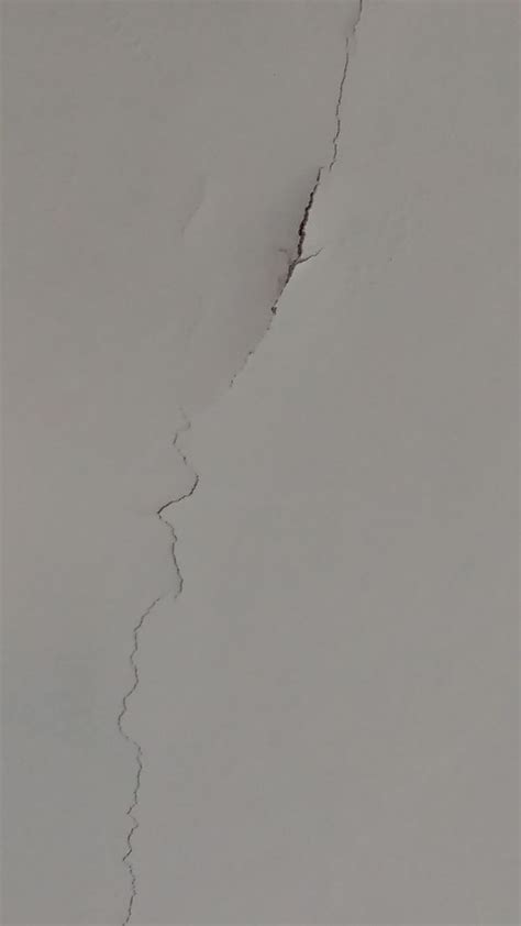 A Man Riding Skis Down The Side Of A Snow Covered Slope