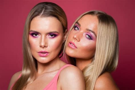 Premium Photo Two Blonde Models With Long Straight Hair And Makeup On Pink Background Two