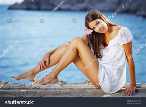 Portrait Of Beautiful Brunette Woman With Long Legs Posing Over Sea View Stock Photo 38338903