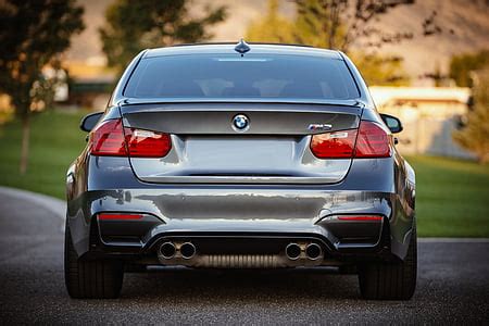 photo black bmw car grey pavement photo sunset hippopx