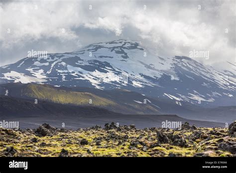 Icelandic volcano with snow and cloudy sky Stock Photo - Alamy