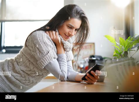 Brunette Girl With Long Hair Talking On Phone With Earphones Stock Photo Alamy