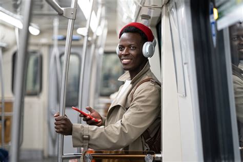 Premium Photo African American Millennial Man In Subway Train Using