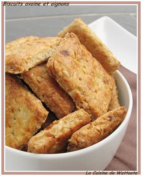 A White Bowl Filled With Biscuits Sitting On Top Of A Table