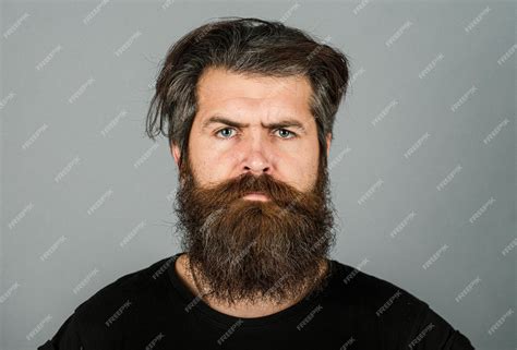 Premium Photo Portrait Of Confident Serious Man Has Beard And Mustache Looks Seriously