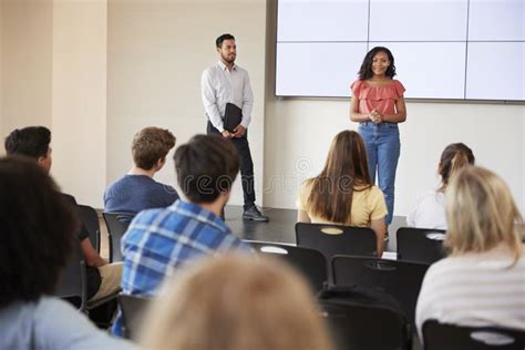 Female Student Giving Presentation To High School Class In Front Of