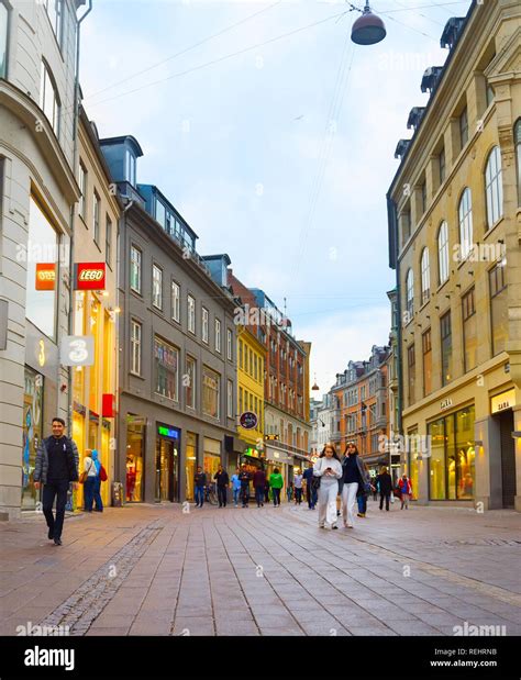 COPENHAGEN, DENMARK - JUNE 16, 2018: People walk by the Stroget street ...