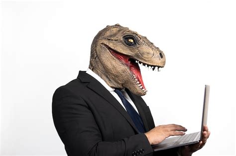 Premium Photo | Executive man with t rex head using his laptop on isolated white background