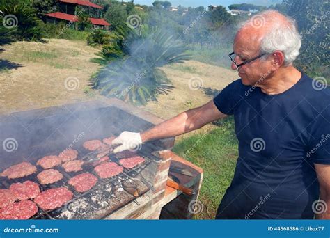 Barbecue Elderly Skilled Man Cooking Bbq Meat Stock Photo Image Of