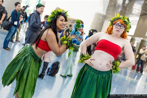 two women in green skirts and red top standing next to each other at an ...