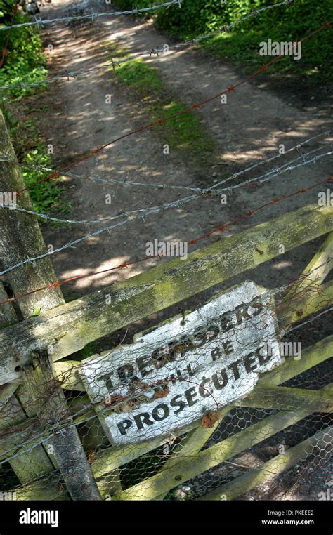 Keep Out Trespassers Will Be Prosecuted Sign On Mesh Metal Fence Stock