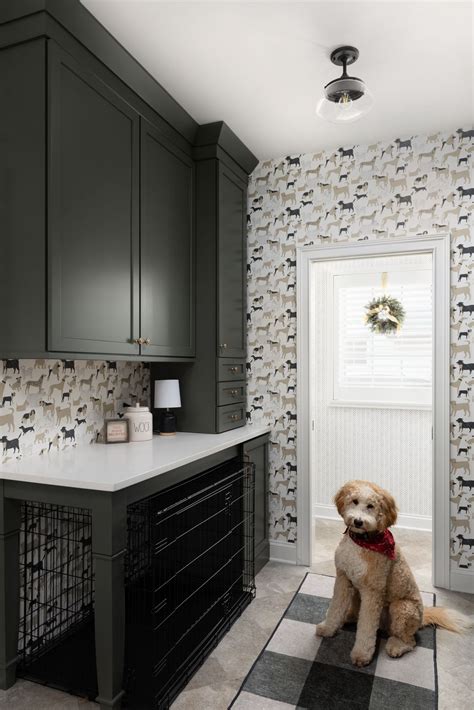 Mudroom with dog wallpaper, green cabinets, and built in dog crate